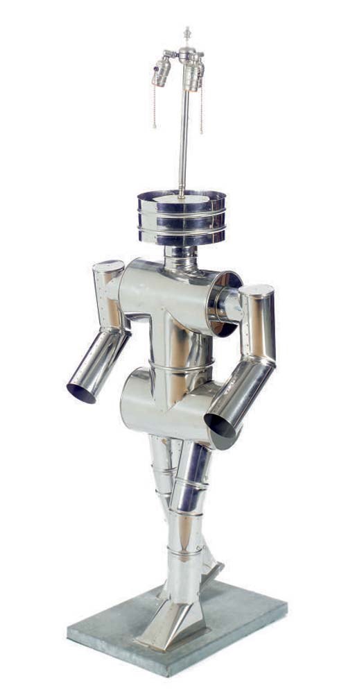 A TIN STANDING LAMP IN THE SHAPE OF A ROBOT,
