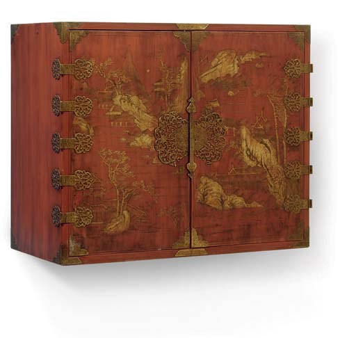 A GILT-DECORATED RED-LACQUERED TWO-DOOR CUPBOARD