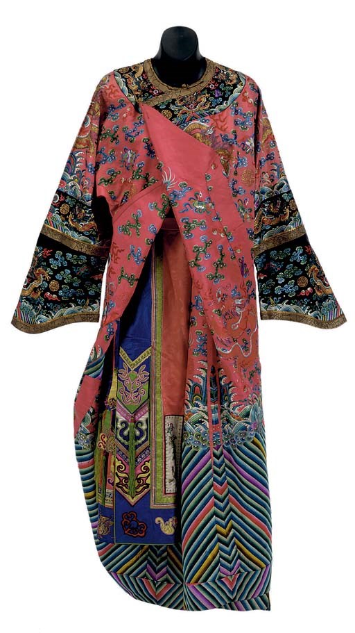 AN EMBROIDERED PINKISH-RED GROUND SILK DRAGON ROBE WITH A MULTI-COLORED SILK SKIRT