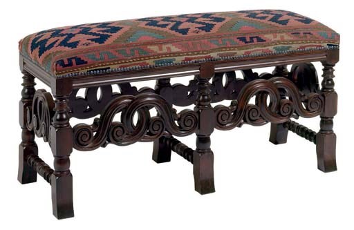 A SPANISH COLONIAL STYLE STAINED WALNUT BENCH