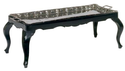 A SILVER PLATE TRAY ON EBONIZED STAND