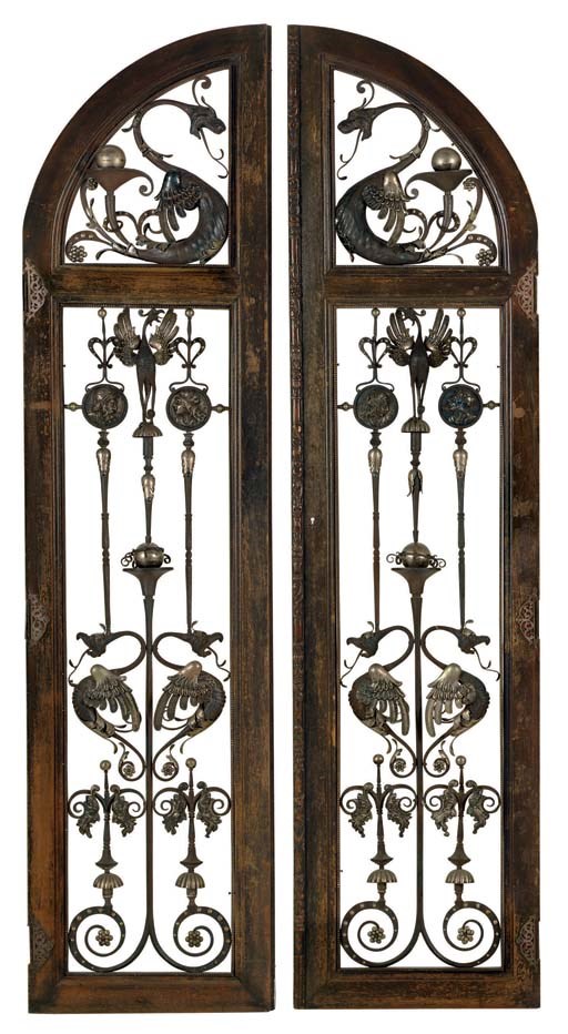 A PAIR OF STAINED WALNUT, WROUGHT IRON, SILVERED-METAL AND PUNCHED TIN DOOR PANELS