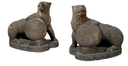 A PAIR OF SPANISH COLONIAL CARVED STONE FIGURES OF LIONS