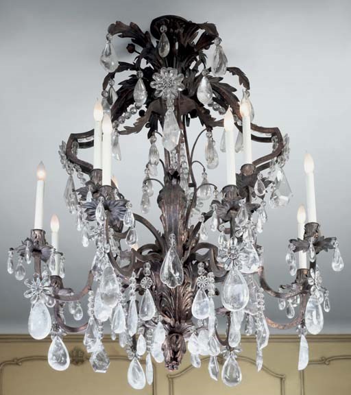 A pair of Continental parcel-gilt, patinated metal, rock-crystal and cut glass twelve-light chandeliers