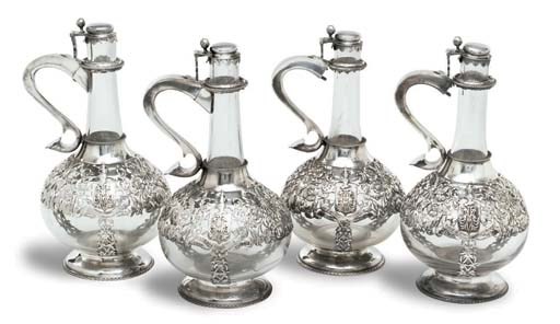 A SET OF FOUR FRENCH SILVER-MOUNTED GLASS CLARET JUGS
