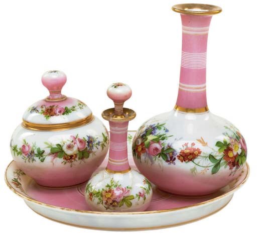AN ENGLISH OR CONTINENTAL PINK GLASS TOILETTE SET