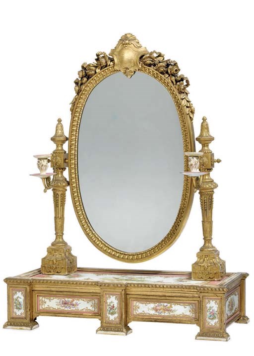 A Napoleon III ormolu, giltwood and Sevres style pink-ground porcelain-mounted dressing-table mirror