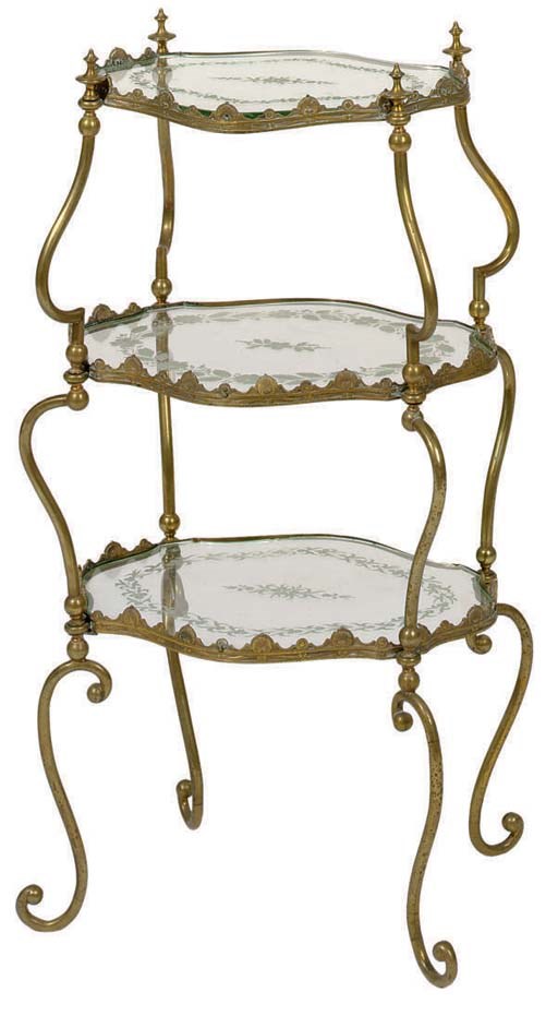 A THREE-TIERED GILT-METAL AND GLASS TABLE,