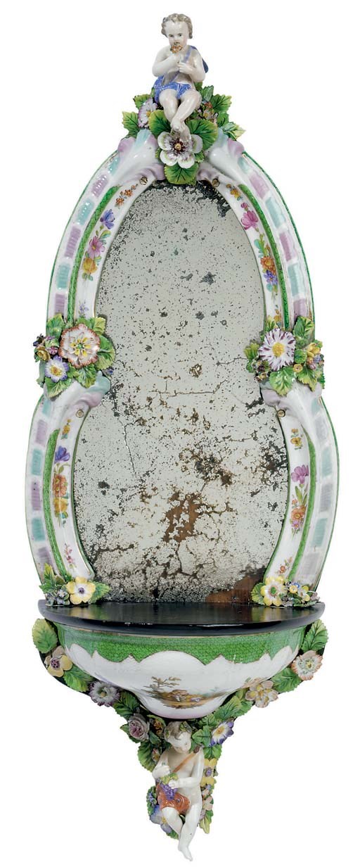 A GERMAN FLOWER-ENCRUSTED GREEN-SCALE GROUND PORCELAIN AND EBONIZED WOOD APPLIQUE