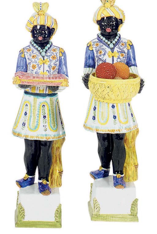 A PAIR OF CONTINENTAL POTTERY MODELS OF BLACKAMOORS,