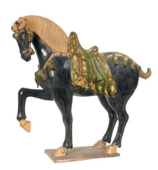 A CHINESE BLUE GLAZED POTTERY FIGURE OF A PRANCING HORSE