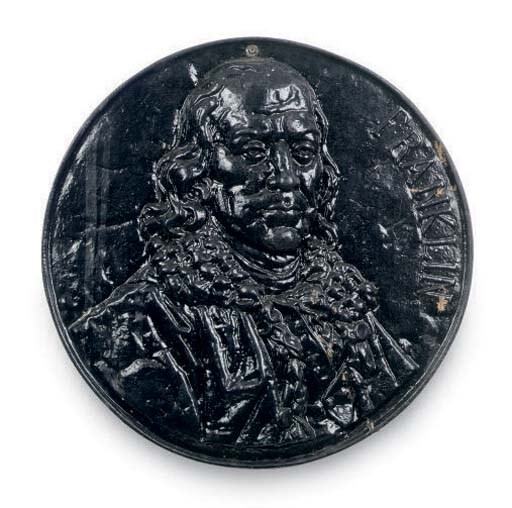 A BLACK PAINTED CAST IRON ROUNDEL OF BENJAMIN FRANKLIN,