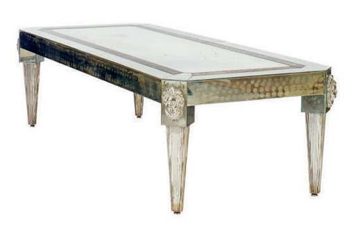 A MIRRORED LOW TABLE WITH CAST GLASS MOUNTS,