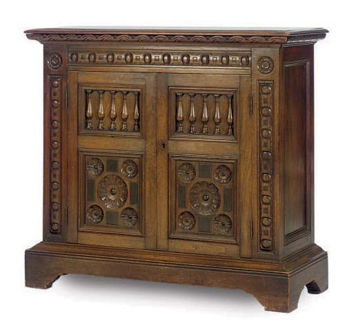A CARVED OAK LOW CUPBOARD,