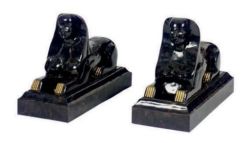 A PAIR OF STONE AND BRASS MOUNTED FIGURES OF SPHINX,
