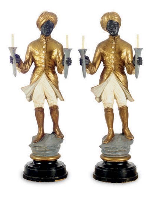 A PAIR OF POLYCHROME PAINTED PLASTER BLACKAMOOR FORM TWO-LIGHT TORCHERES,