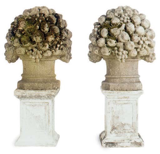 A PAIR OF CAST COMPOSITION FRUIT FORM BASKETS ON BASES,