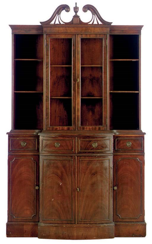 A MAHOGANY BOMBE SHAPED CUPBOARD,
