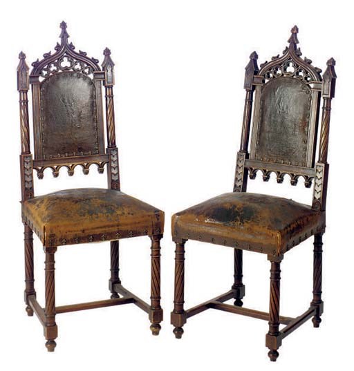 A SET OF EIGHT CARVED AND STAINED WALNUT GOTHIC REVIVAL DINING CHAIRS,