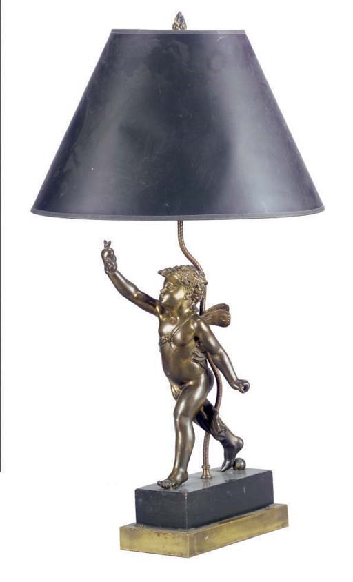 A GILT-METAL FIGURE OF CUPID MOUNTED AS A LAMP,