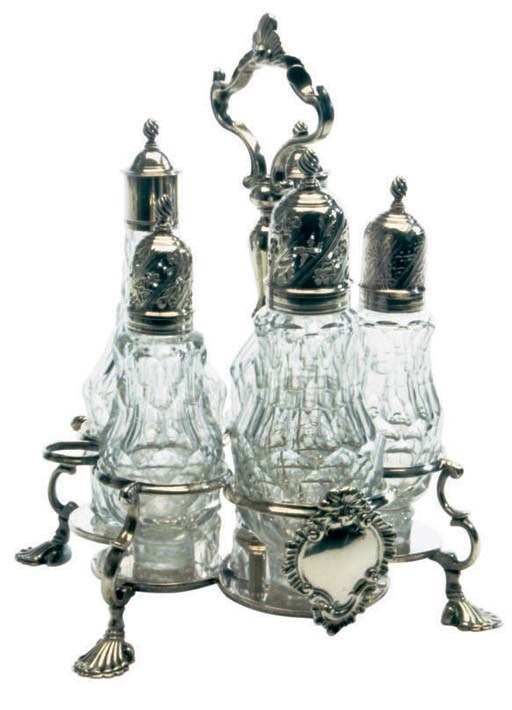 A GEORGE III SILVER AND GLASS CRUET STAND
