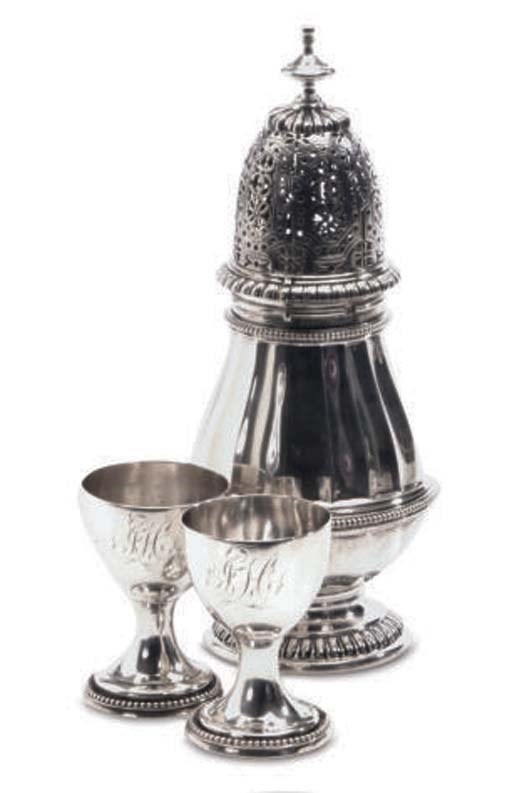 THREE ENGLISH SILVER EGG CUPS AND A PORTUGUESE SILVER SUGAR CASTER AND COVER,