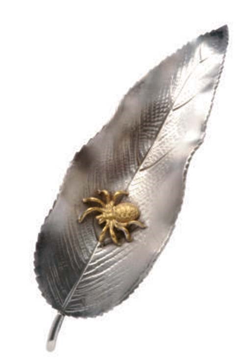 AN AMERICAN PARCEL-GILT SILVER BROOCH,