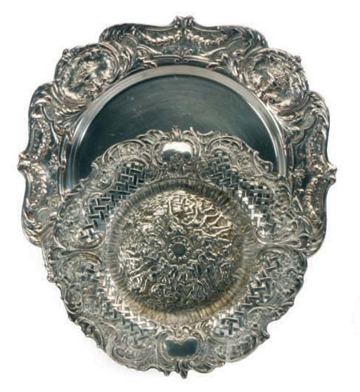 A SET OF TWELVE SILVER-PLATED CHARGERS,