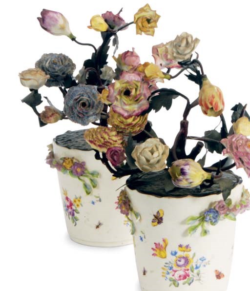 A PAIR OF TÔLE AND PORCELAIN MENNECY STYLE POTS OF FLOWERS,