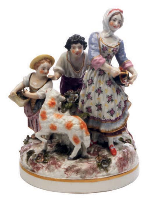 A MEISSEN STYLE PORCELAIN FIGURE GROUP OF A SHEPHERDESS PLAYING A HURDY GURDY WITH CHILDREN AND A LAMB,