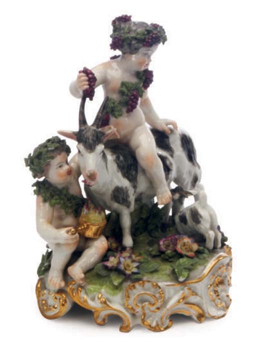 A MEISSEN STYLE PORCELAIN GROUP OF INFANT BACCHUS ASTRIDE A GOAT,