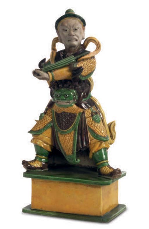 A CHINESE GREEN, AUBERGINE, AND GREEN GLAZED FIGURE OF A MAN,