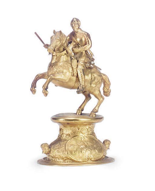 A GILT-METAL FIGURE ON HORSEBACK,