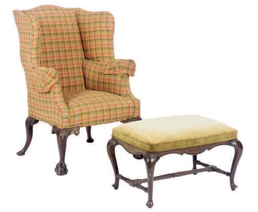 AN ENGLISH MAHOGANY WINGBACK ARMCHAIR TOGETHER WITH A FOOT STOOL,