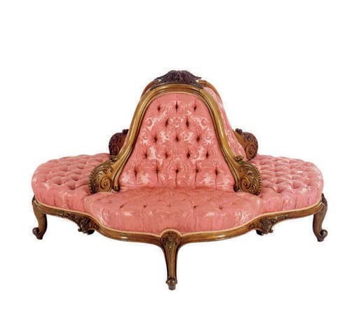 A VICTORIAN WALNUT AND ROSEWOOD GRAINED CONFIDANTE**,