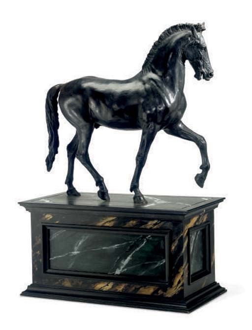 A PATINATED METAL FIGURE OF A STRIDING HORSE
