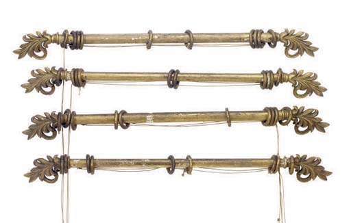 A SET OF FOUR AMERICAN GILTWOOD CURTAIN RODS WITH CARVED PALMETTES AT EACH END,