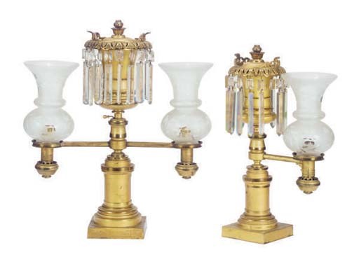 AN AMERICAN GILT-METAL THREE-PIECE FLUID GARNITURE WITH FROSTED GLASS SHADES,