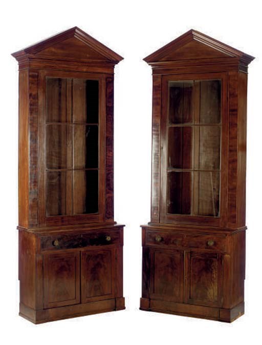 A PAIR OF LATE CLASSICAL MAHOGANY BOOKCASE CABINETS,