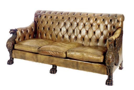 A VICTORIAN CARVED MAHOGANY AND TUFTED LEATHER UPHOLSTERED SOFA,