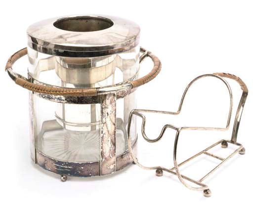 A CYLINDRICAL GLASS WINE COOLER AND A WIREWORK BOTTLE HOLDER