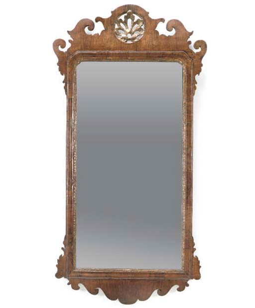 A WALNUT FRET-CARVED MIRROR
