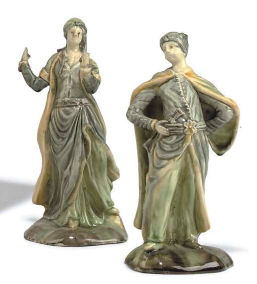 A PAIR OF CREAMWARE FIGURES OF A TURK AND COMPANION