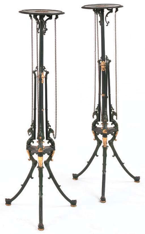 A PAIR OF GERMAN GREEN PAINTED AND PARCEL-GILT CAST IRON TORCHERE STANDS
