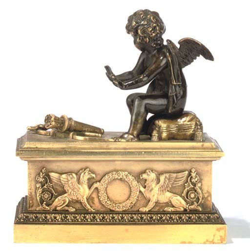 AN EMPIRE BRONZE AND GILT BRONZE CHENET