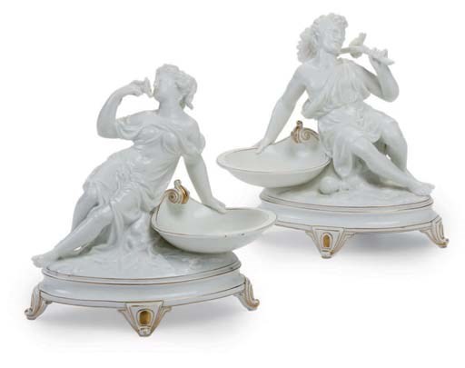 TWO CONTINENTAL PORCELAIN WHITE AND GILT FIGURAL SWEETMEAT DISHES