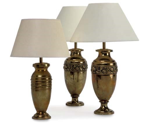 A PAIR OF REPOUSSE BRASS TABLE LAMPS, AND ANOTHER SIMILAR SMALLER TABLE LAMP