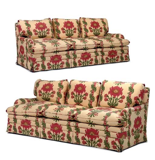 A PAIR OF YELLOW, GREEN AND RED-FLORAL COTTON UPHOLSTERED THREE-SEAT SOFAS