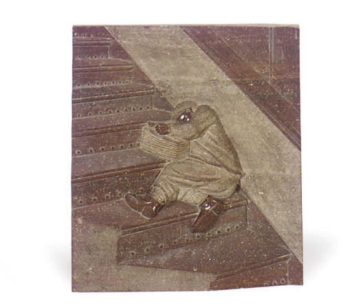 A CARVED RED GRANITE PLAQUE TITLED 'NEWSBOY,'