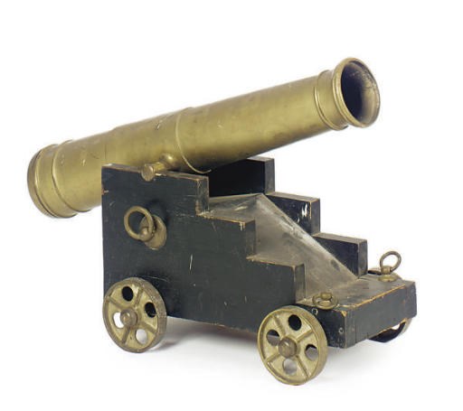 A BRASS MINIATURE CANNON ON WOOD BASE,